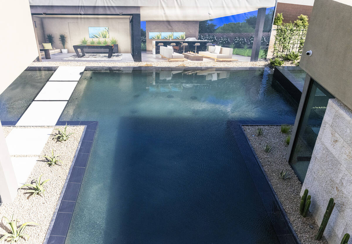 The swimming pool is seen outside the newly finished house at the Oasi homes, built by Blue Her ...