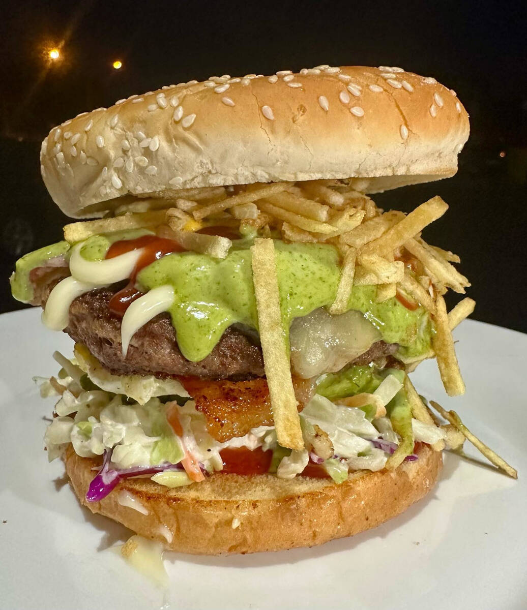 A Venezuelan hamburger layering beef, pork, egg, avocado and crisp strips from Rika Arepa Expre ...