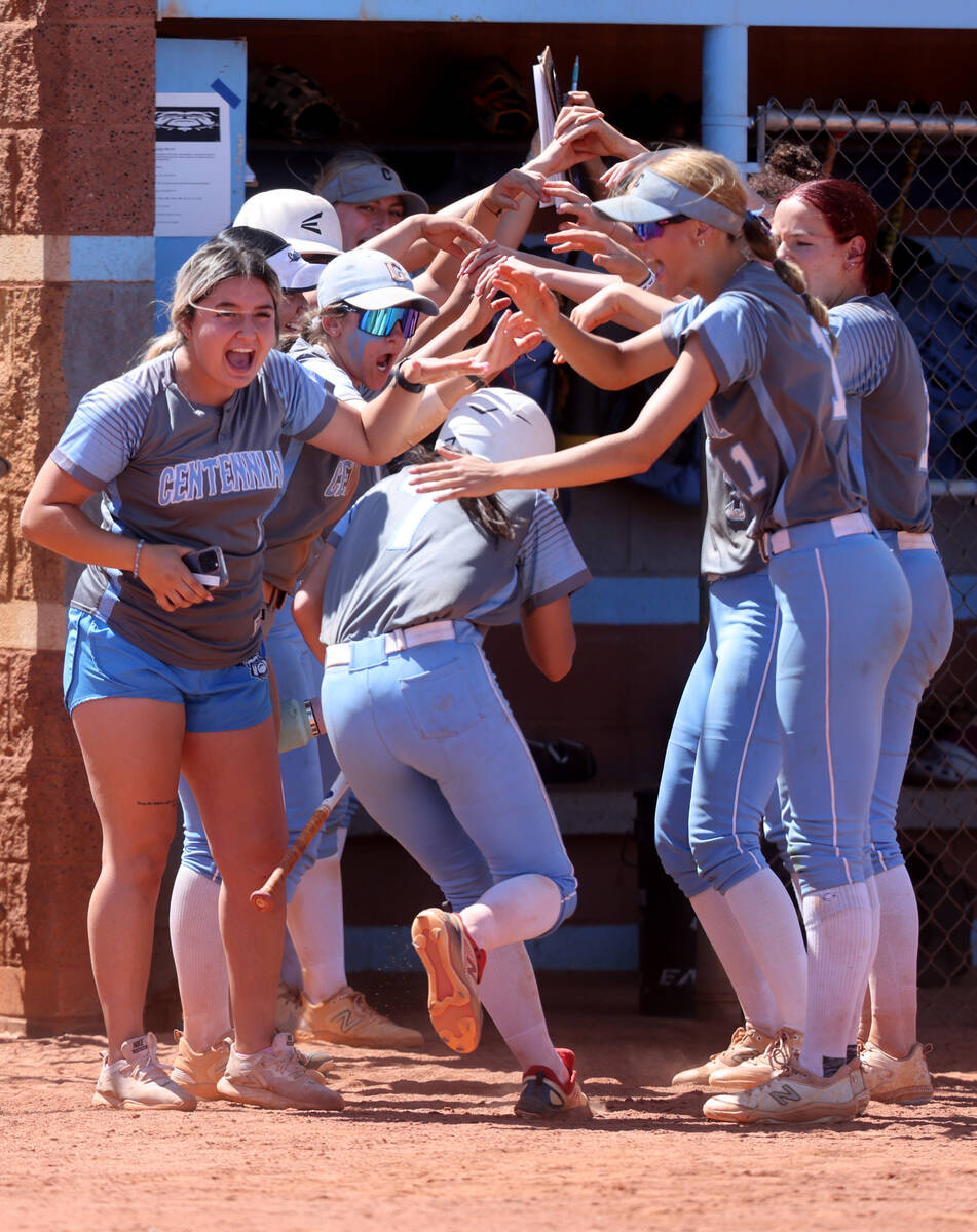 Centennial players congratulate Rebeca Venzor-Nuno (7) for hitting a home run in the 2nd inning ...