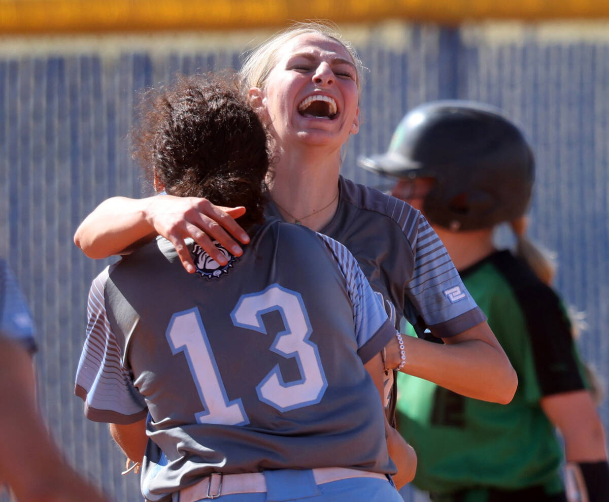 Centennial players, including pitcher Teagan Clemmons, right, and Keana Bell (13) celebrate bea ...