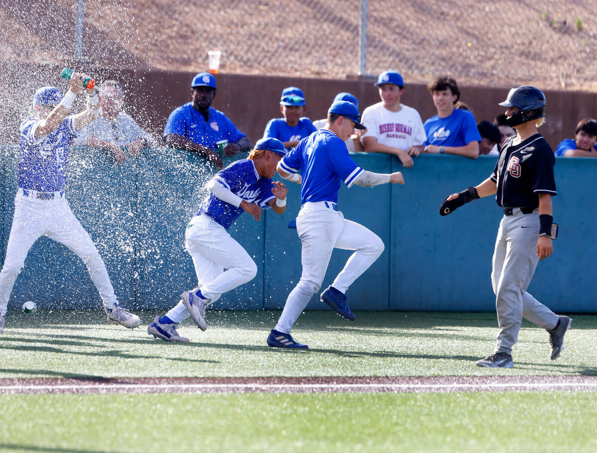 Bishop Gorman High School players celebrate their 10-3 win against Desert Oasis High during the ...