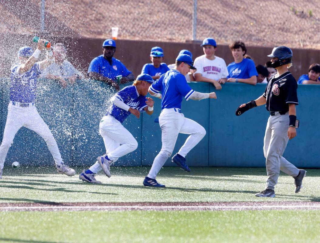 Bishop Gorman High School players celebrate their 10-3 win against Desert Oasis High during the ...