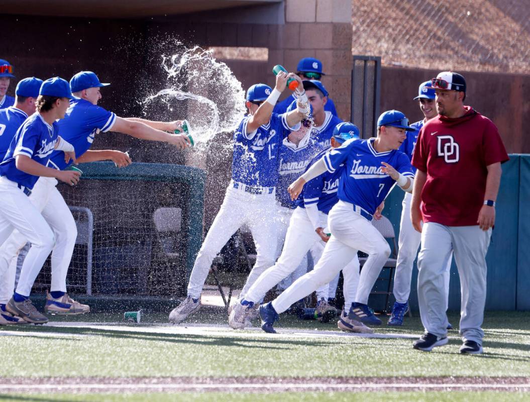 Bishop Gorman High School players celebrate their 10-3 win against Desert Oasis High during the ...