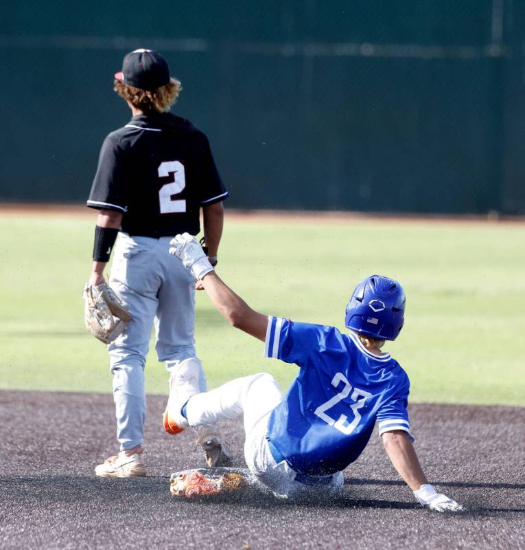 Bishop Gorman High's Aiden Pollock (23) slides safe at second as Desert Oasis High's Lincoln Gu ...