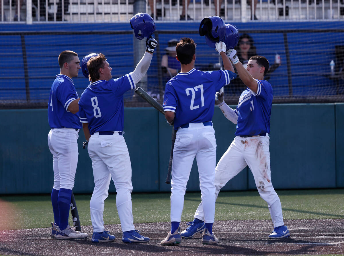 Bishop Gorman High's Billy Scaldeferri (11) congratulated by his teammates after hitting a two ...