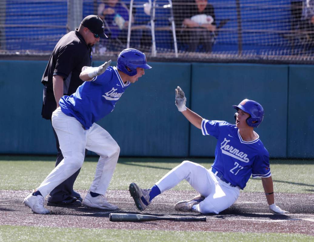 Bishop Gorman High's Nolan Eberwein (27) congratulated by his teammate Burke Mabeus after hitti ...