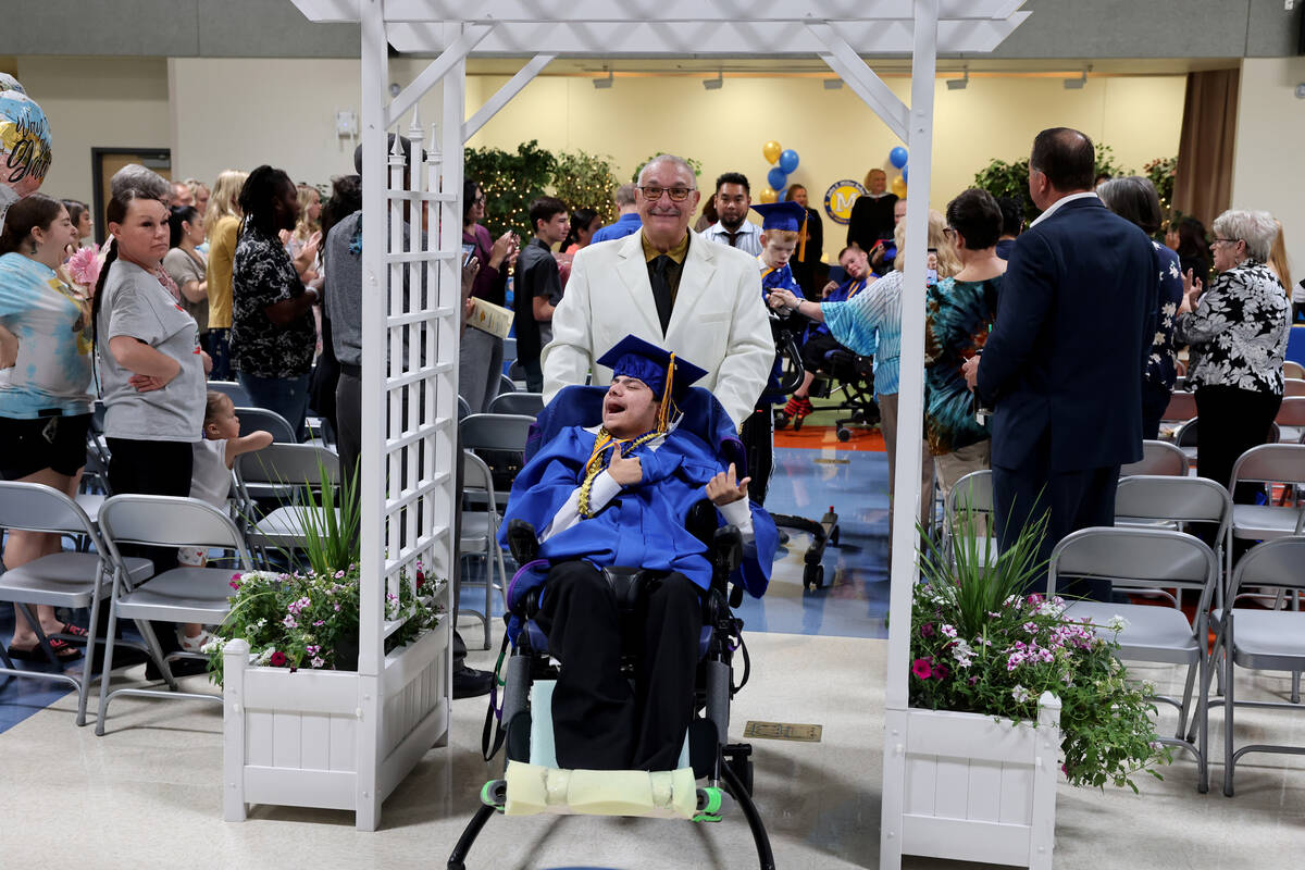 Graduate Alexander Excobar-Gomez walks in the recessional with Special Education Instructional ...
