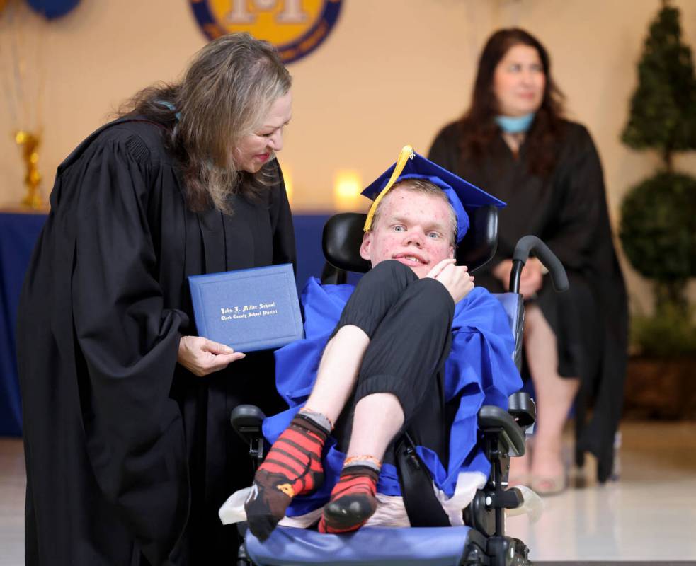 Graduate James Schiess gets his diploma from Clark County School Board Trustee Linda Cavazos du ...