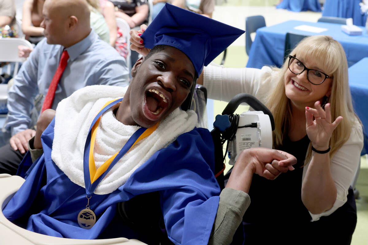 Graduate Kevin Akitani-Bob with Speech and Language Pathologist Garleen Hutchings during a grad ...