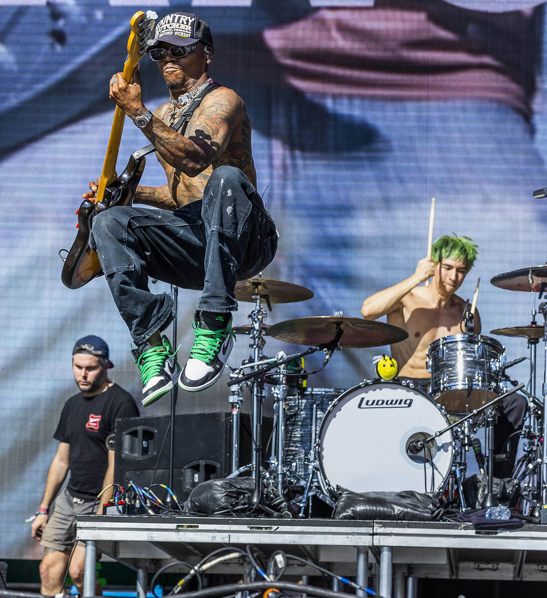 Turnstile guitarist Franz Lyons leaps in the air as they perform during the Sick New World fest ...