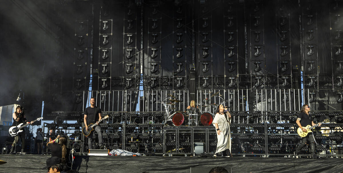 Evanescence lead singer Amy Lee, center, performs with the band during the Sick New World festi ...
