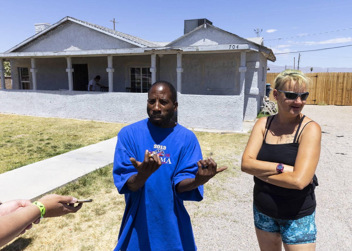 Darnell Fisher, left, speaks during an interview with the Review-Journal as his wife Amie looks ...