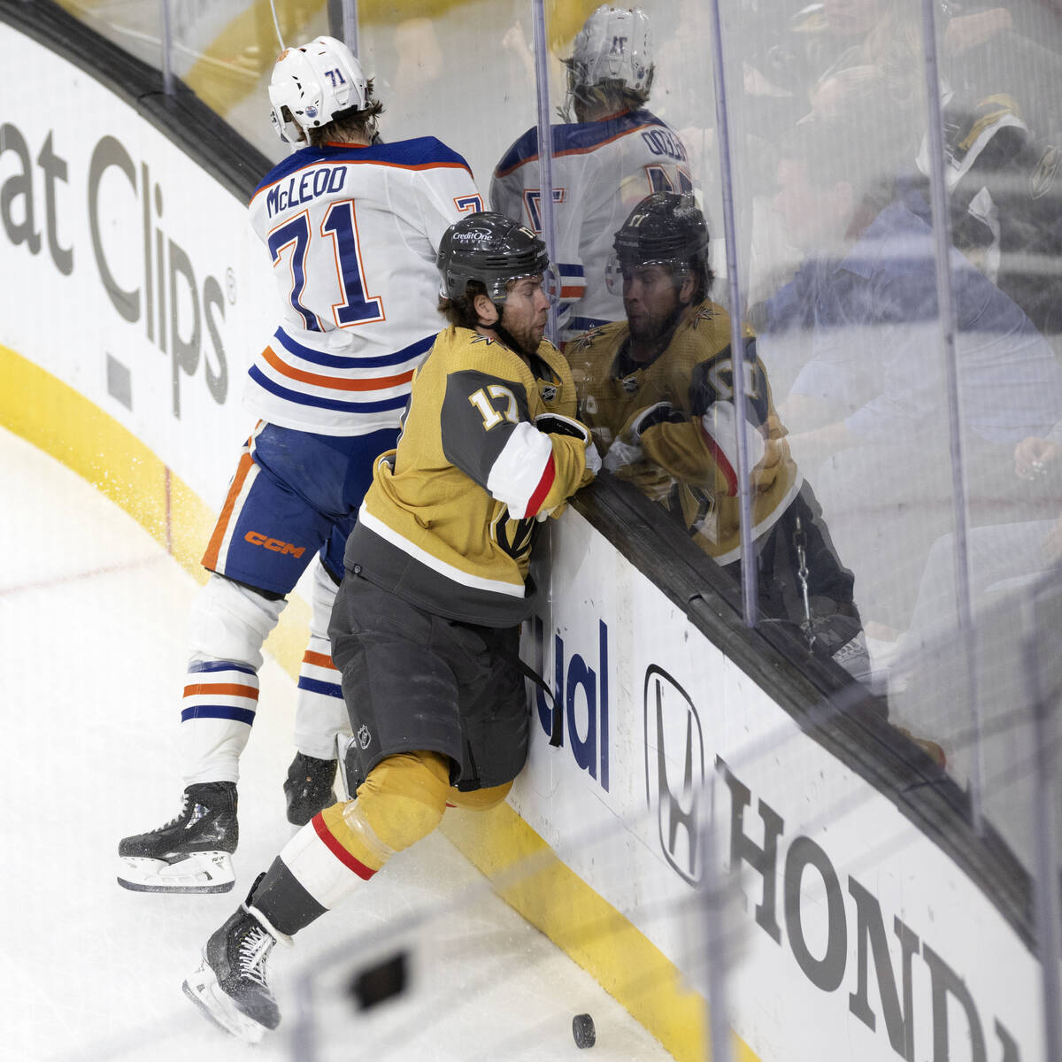 Edmonton Oilers center Ryan McLeod (71) slams Golden Knights defenseman Ben Hutton (17) into th ...