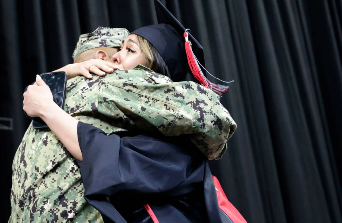 U.S. Navy Petty Officer 2nd Class Douglas Hernandez hugs his daughter Pamela after she received ...