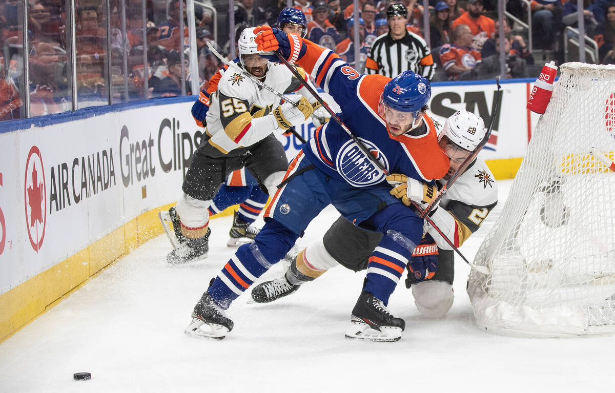 Vegas Golden Knights' William Carrier (28) and Edmonton Oilers' Mattias Janmark (26) battle for ...