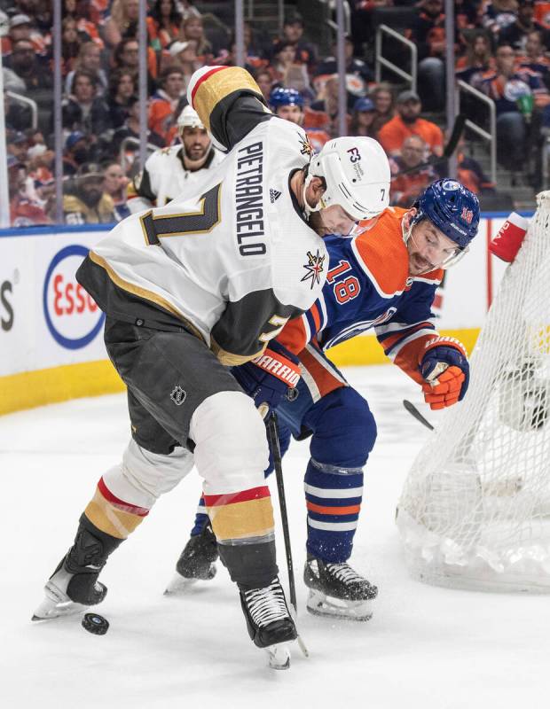 Vegas Golden Knights' Alex Pietrangelo (7) and Edmonton Oilers' Zach Hyman (18) battle for the ...