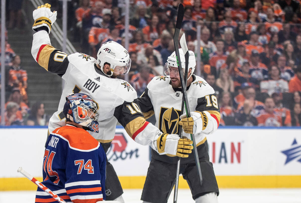 Vegas Golden Knights right wing Reilly Smith (19) celebrates his goal with teammate Nicolas Roy ...