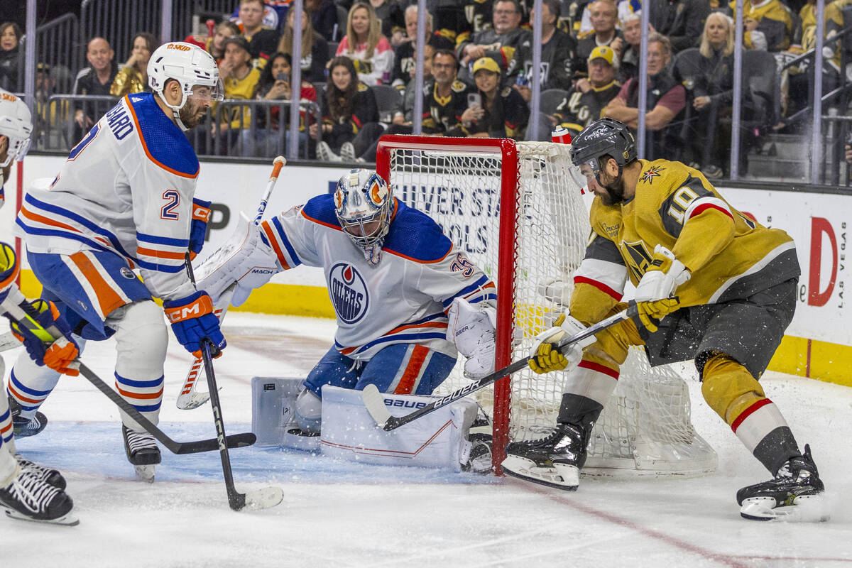 Edmonton Oilers goaltender Jack Campbell (36) traps a shot on goal by Golden Knights center Nic ...