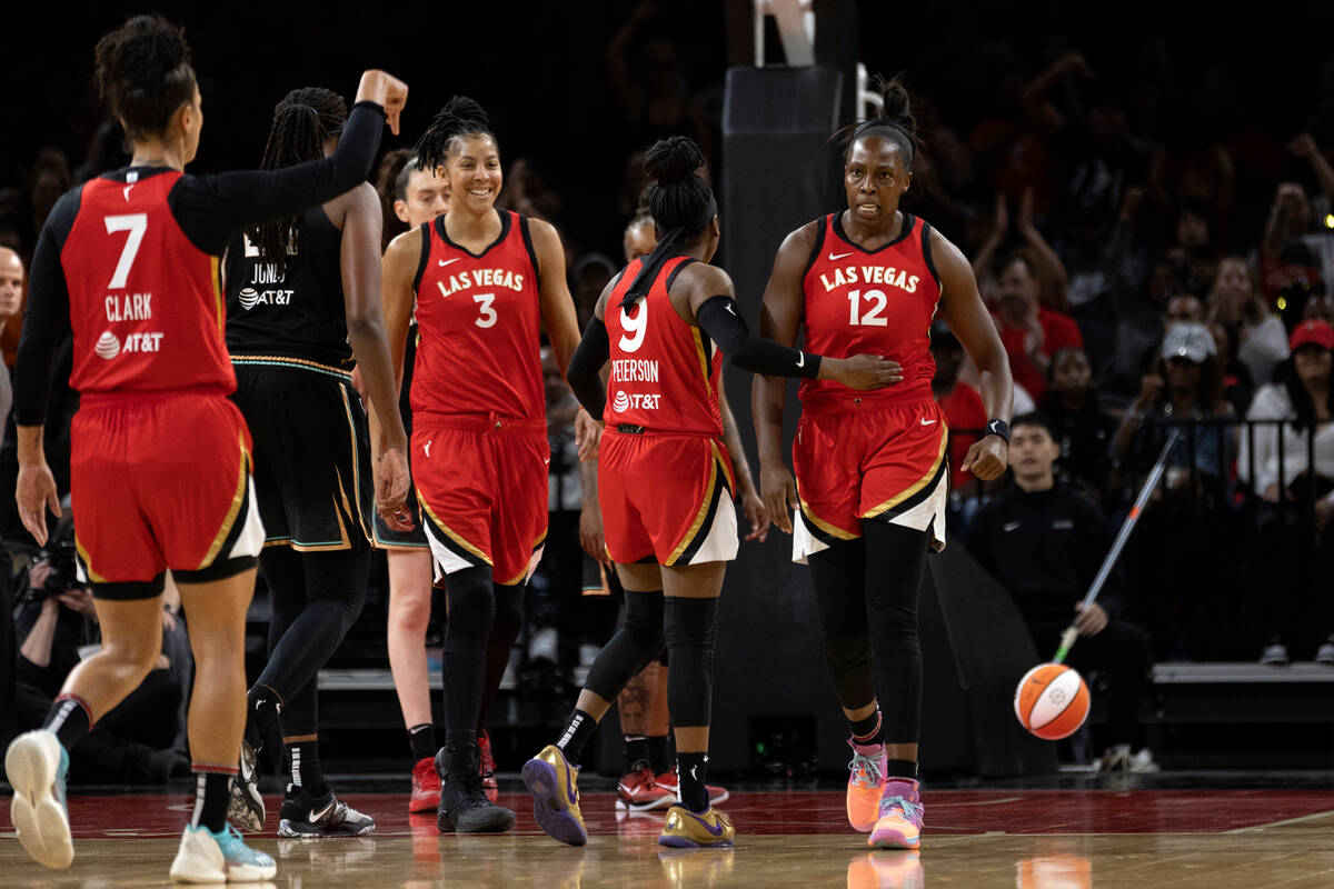 The Las Vegas Aces celebrate after guard Chelsea Gray (12) scored during the first half of a WN ...