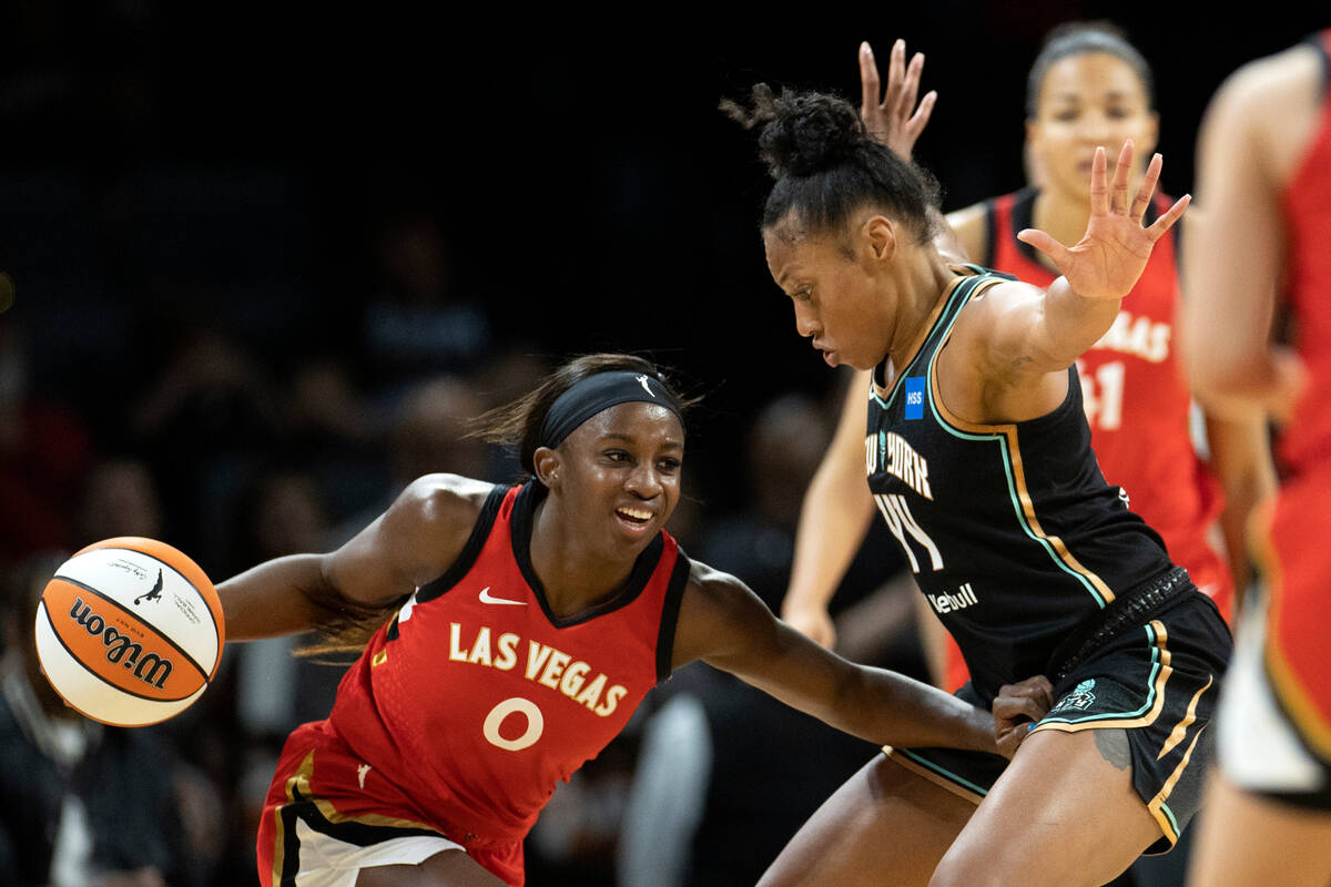 Aces guard Jackie Young (0) drives around New York Liberty forward Betnijah Laney (44) during t ...