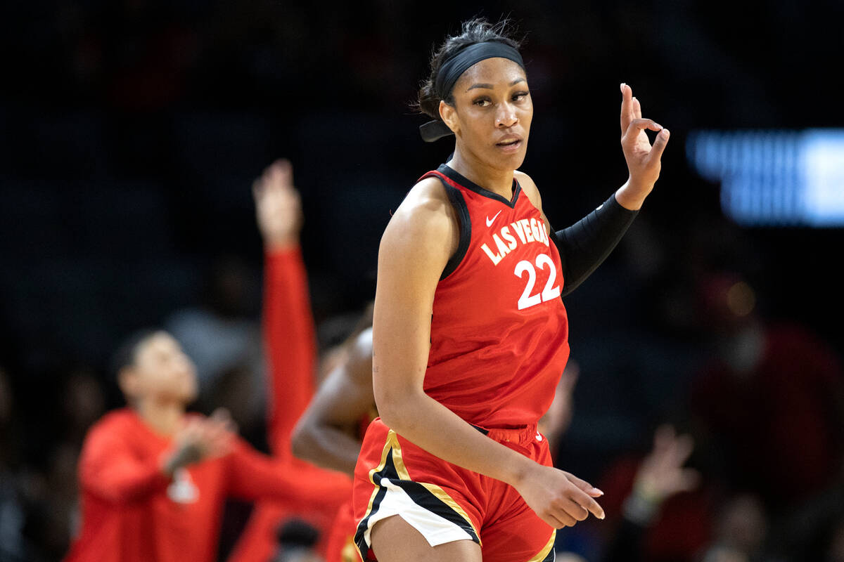 Aces forward A'ja Wilson (22) signals after scoring a three-pointer during the first half of a ...