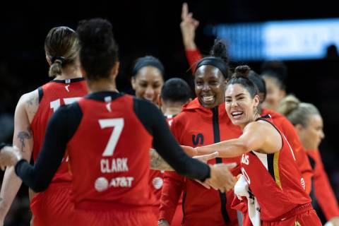Aces guard Kelsey Plum, right, and guard Chelsea Gray, second from right, slap hands with cente ...