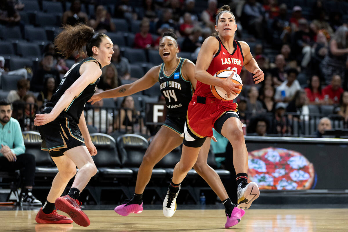 Aces guard Kelsey Plum (10) weaves between New York Liberty forward Breanna Stewart (30) and fo ...