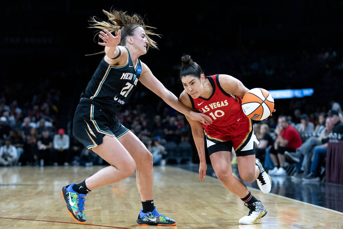 Aces guard Kelsey Plum (10) drives around New York Liberty guard Sabrina Ionescu (20) during th ...