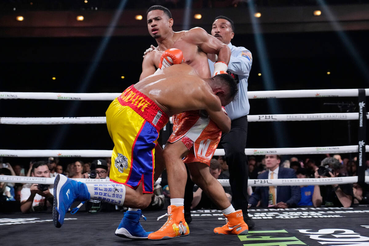 Rolando Romero, right, fights Ismael Barroso in a super lightweight title boxing match Saturday ...