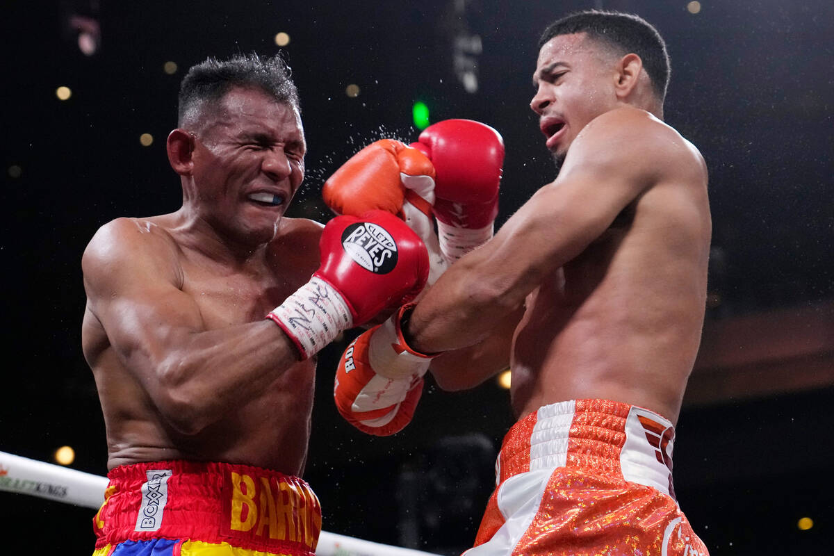 Rolando Romero, right, fights Ismael Barroso in a super lightweight title boxing match Saturday ...