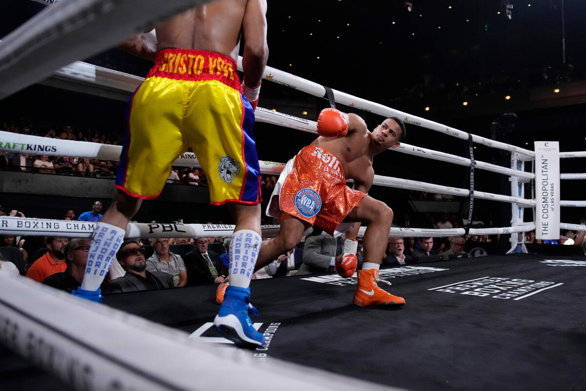 Ismael Barroso, left, knocks down Rolando Romero in a super lightweight title boxing match Satu ...