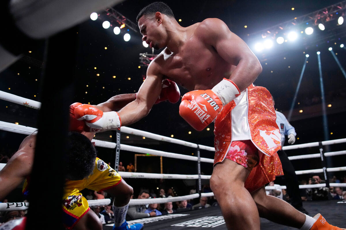 Rolando Romero knocks down Ismael Barroso in a super lightweight title boxing match Saturday, M ...