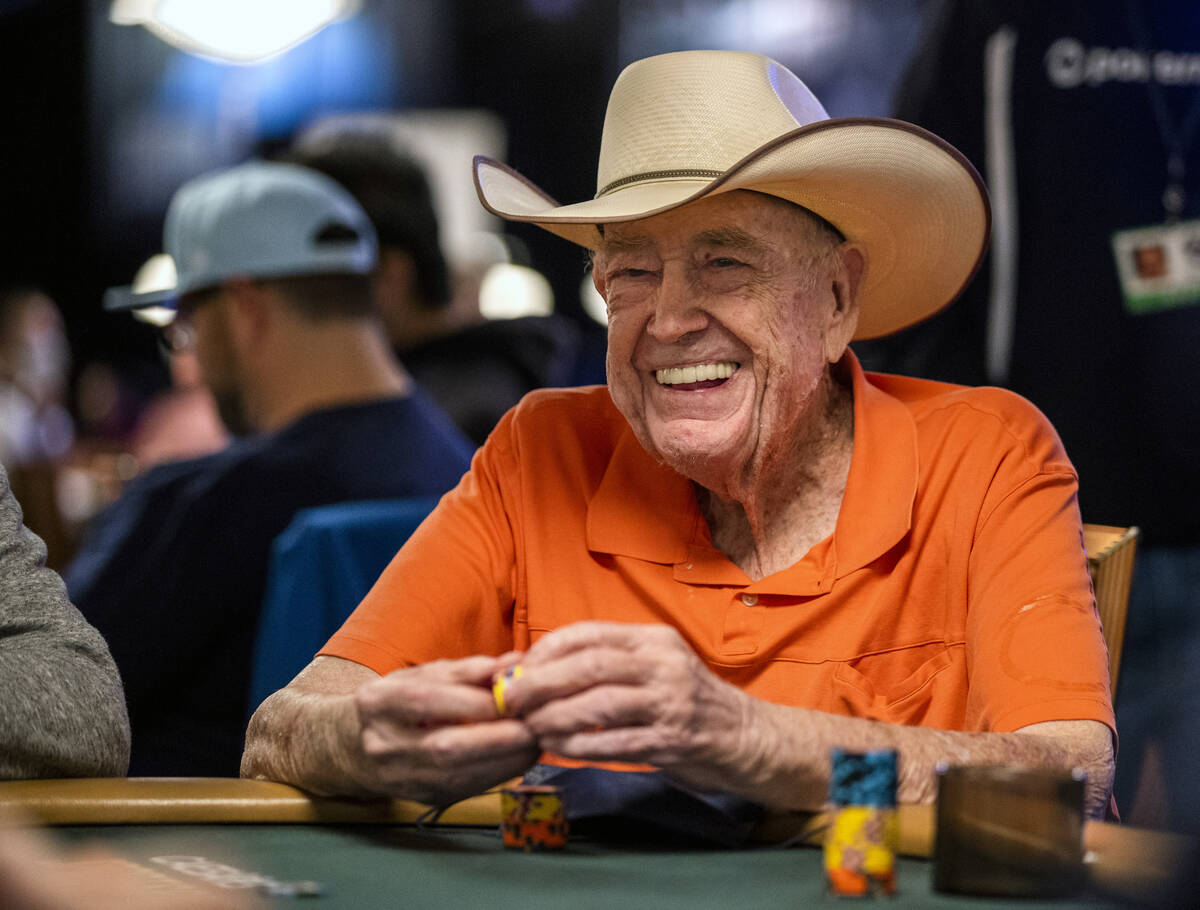 Legendary poker player Doyle Brunson joins others at a table during Day 1A of the $10,000 buy-i ...