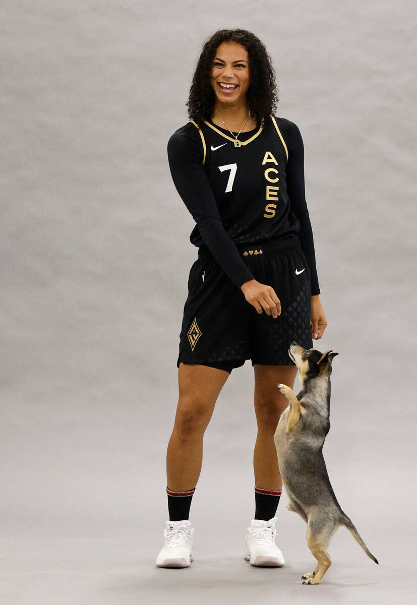 Las Vegas Aces’ Alysha Clark poses for a photo with her dog Sly, during their media day, ...