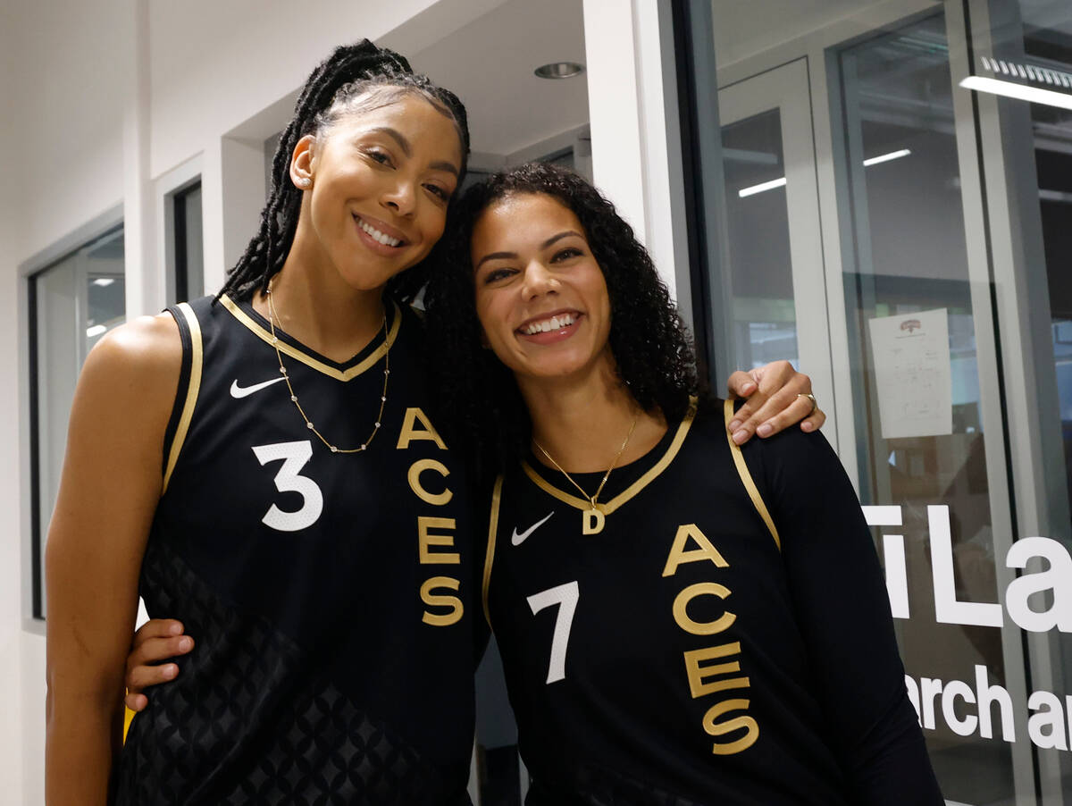 Las Vegas Aces’ Candace Parker, left, and her teammate Alysha Clark smile together durin ...