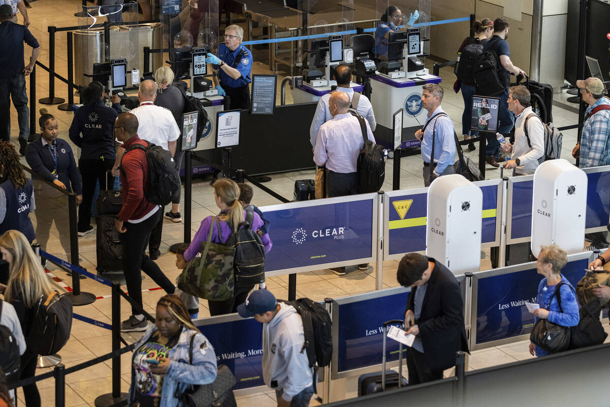 Travelers wait in line at a Baltimore-Washington airport security checkpoint to use the TSA's n ...