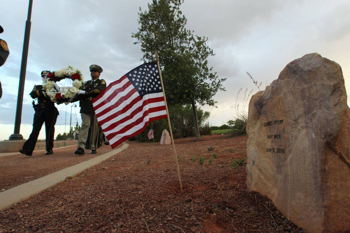 A wreath is carried past a marker during a memorial in 2015 for Metro officers Igor Soldo and A ...