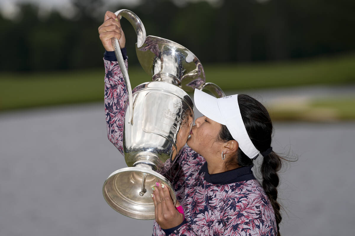 Lilia Vu kisses the trophy after winning in a playoff against Angel Yin in the Chevron Champion ...