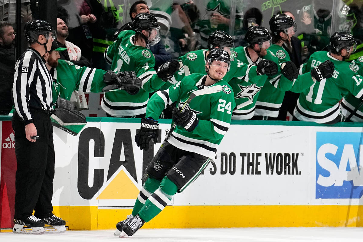Dallas Stars center Roope Hintz (24) smiles as he celebrates with the bench after scoring again ...