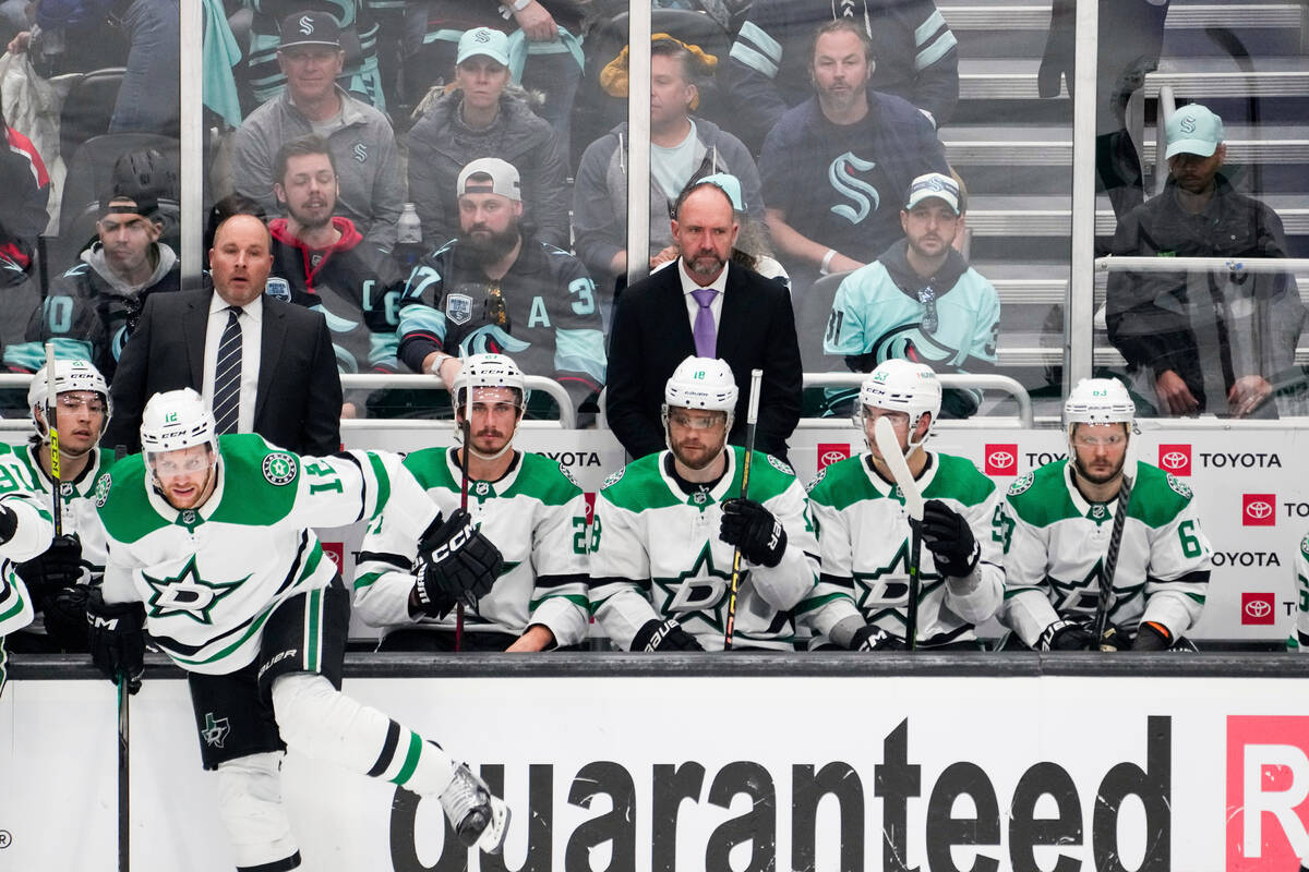 Dallas Stars head coach Peter DeBoer, center, looks on during the third period of Game 3 of an ...