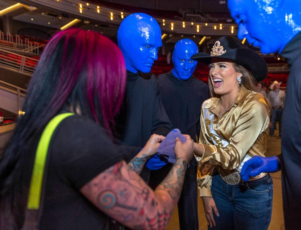 Miss Rodeo America Kennadee Riggs laughs as she has some blue paint removed from her fingers af ...