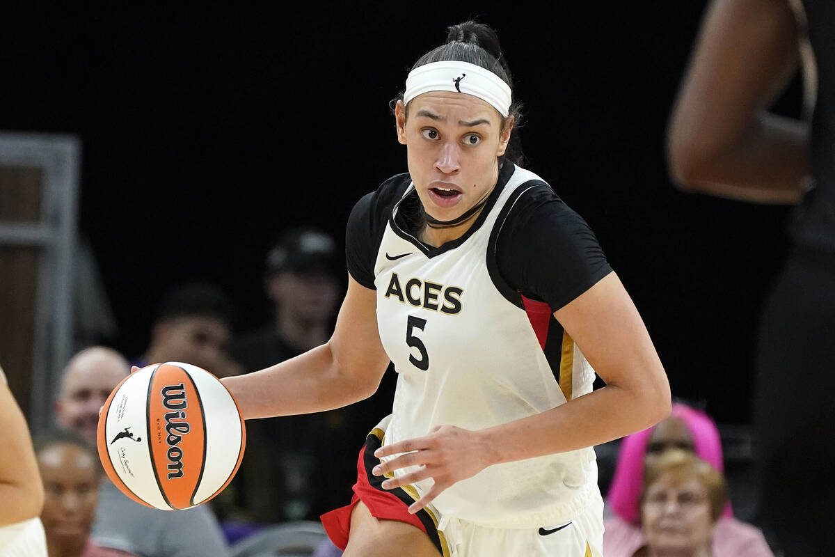 Las Vegas Aces' Dearica Hamby (5) dribbles up court during a WNBA basketball game against the P ...