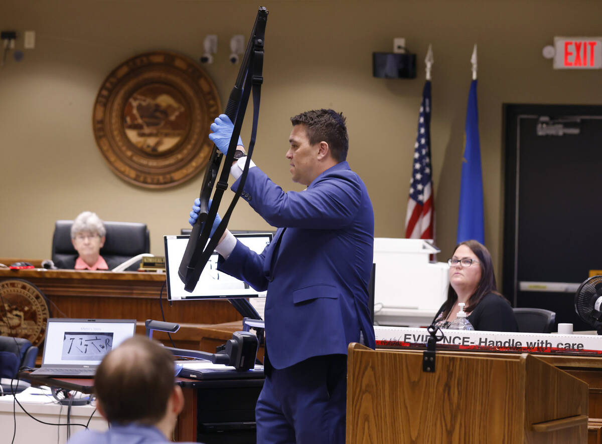 Jason Gunnell, senior deputy district attorney, holds a shotgun, allegedly used by Brad Mehn, o ...