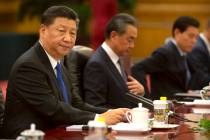 Chinese President Xi Jinping sits during a meeting at the Great Hall of the People in Beijing i ...