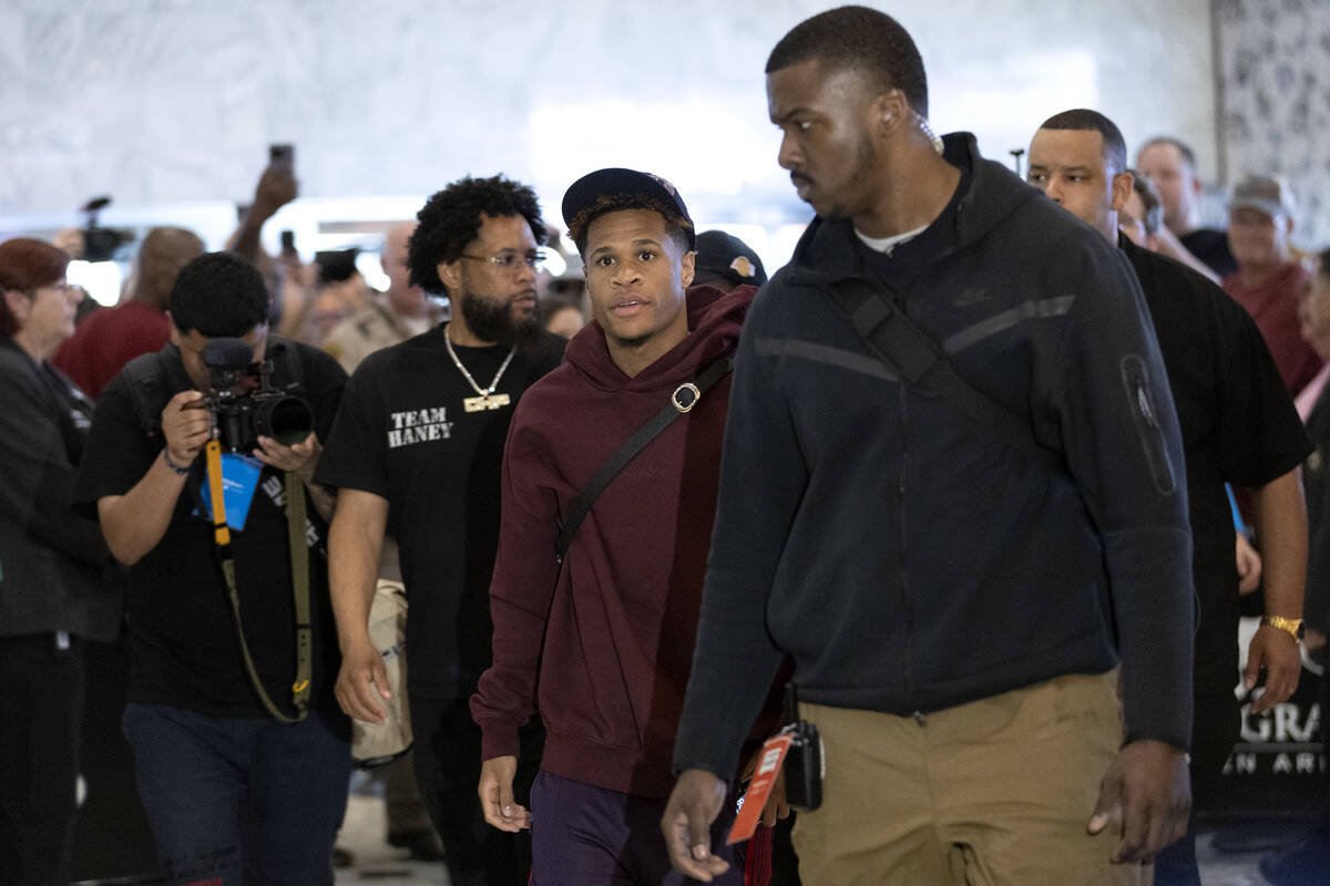 Devin Haney, center, arrives to MGM Grand ahead of his Saturday night undisputed lightweight bo ...