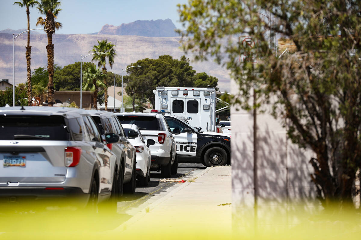 Police at the scene where three people were shot, including one fatally, in southwest Las Vegas ...