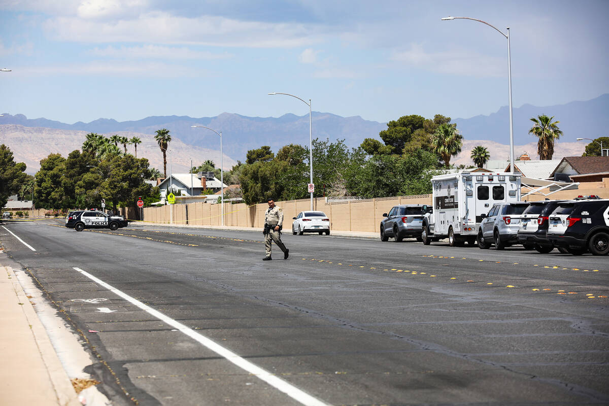 Police at the scene where three people were shot, including one fatally, in southwest Las Vegas ...