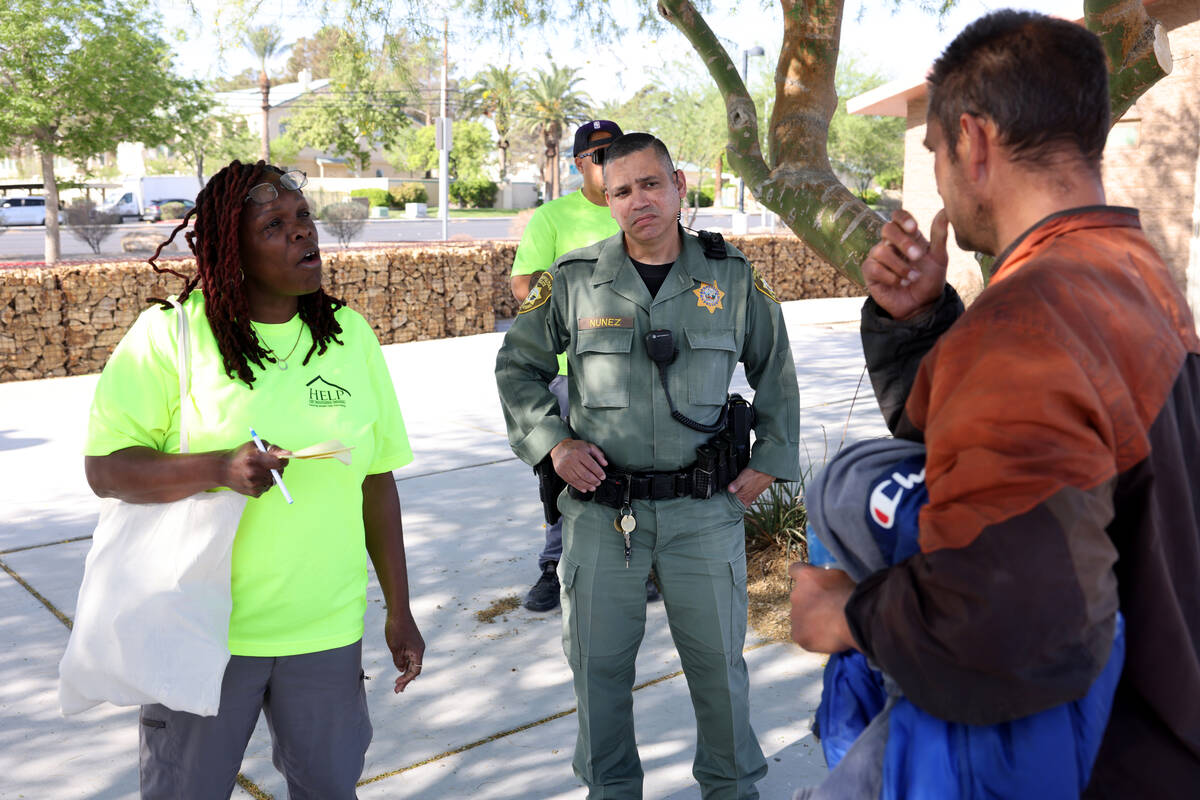 Officer Angel Nunez with Metropolitan Police Department’s Homeless Outreach Team, center ...