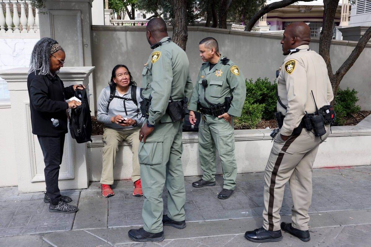 Joe Jayrando, seated, talks to members of Metropolitan Police Department’s Homeless Outr ...