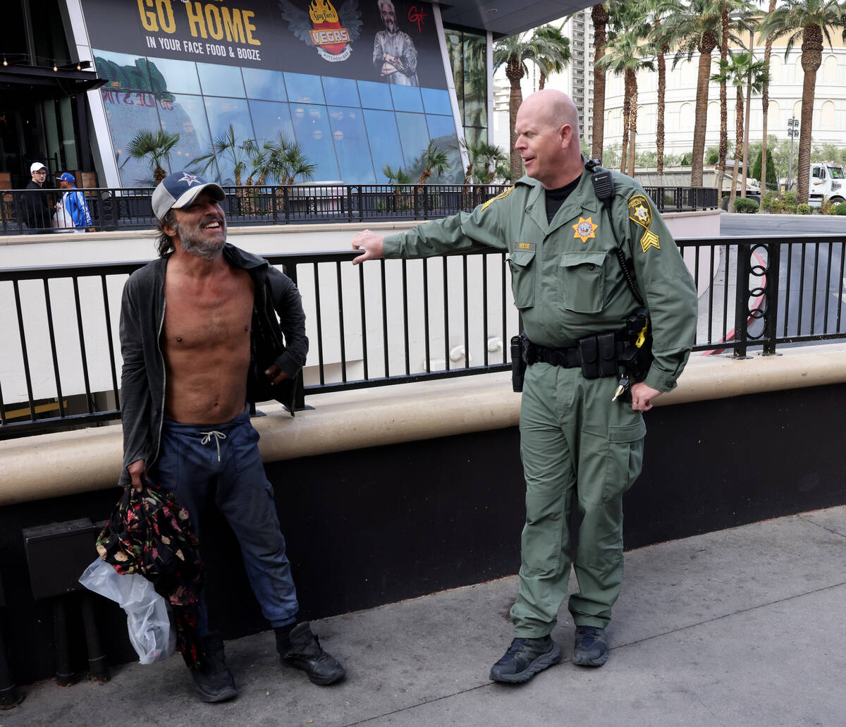 Metropolitan Police Department Homeless Outreach Team Sgt. Steven Reese, talks to James Castro ...